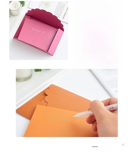 Close-up of pearlized envelopes with scallop edges and matching blank insert cards