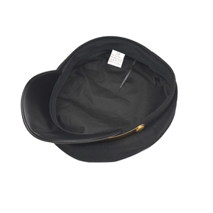 Detail of internal size tag and washing label showing cotton blend on a black newsboy cap