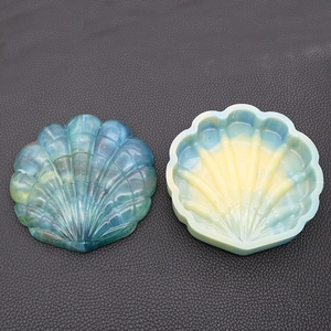 Macro detail of a sea shell resin mold set with translucent gradient blue and yellow colors