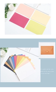 Detailed view of colorful pearlescent envelope set with a gold heart clasp on paper