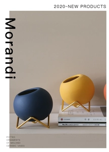 Detail showing blue Morandi ceramic flower vase with geometric golden metal tripod stand