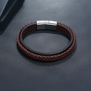 Detail view of double-layer brown leather bracelet with silver magnetic metal clasp