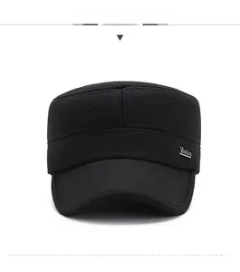Front view detail of a black wool cadet cap with a metallic decorative side emblem