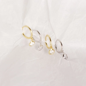Detailed shot of S925 silver hoop earrings with round white zircon in gold and silver