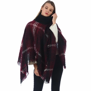 Detail of high neck poncho with burgundy plaid knit fabric and fringe hemline