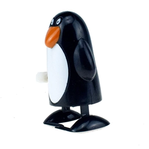 Close-up of a wind-up penguin toy in black and white plastic with an orange beak detail