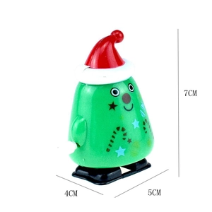 Detail showing dimensions of 7cm x 5cm x 4cm for a green Christmas wind-up toy