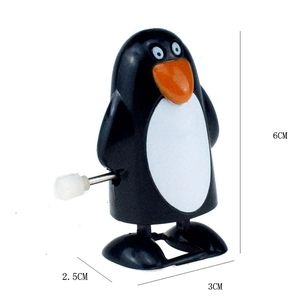 Detail view of penguin wind-up toy with mechanical knob and 6cm height measurements