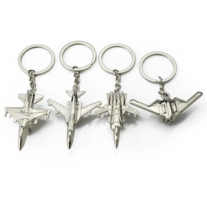 Set of four silver metal fighter jet aircraft model keychains with detailed engravings