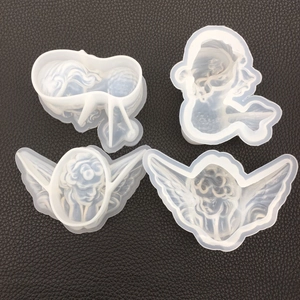 Detail of four transparent silicone molds featuring angel and cupid embossed designs