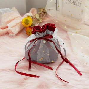 Close-up of red velvet candy bag with star moon mesh and pearl pendant detail