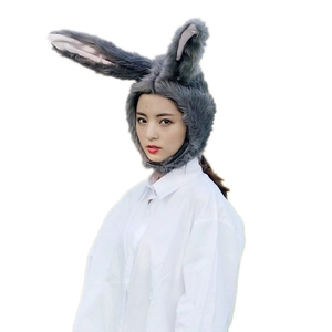 Cute grey plush rabbit ear hat accessory worn by a model against a white background