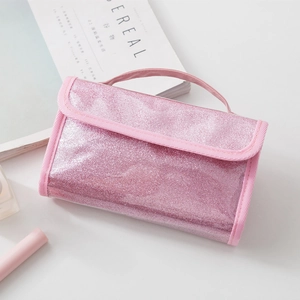 Pink glitter waterproof PVC travel makeup bag with handle and snap closure shown at 45 degrees