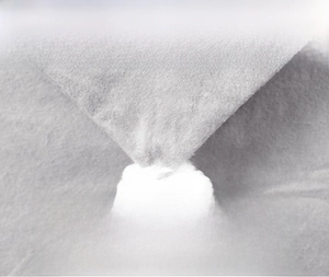 Detailed macro view showing premium gray non-woven fabric and soft white pompom ornament