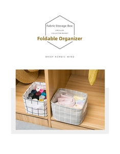 Detail of foldable cotton linen organizers with side handles in a closet setup