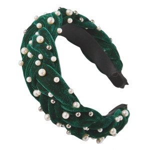 Detail of emerald velvet braided headband with intricate pearls and gold metal bead studs