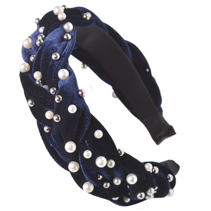 Close-up of dark blue velvet braided headband with white pearls and silver beads detail