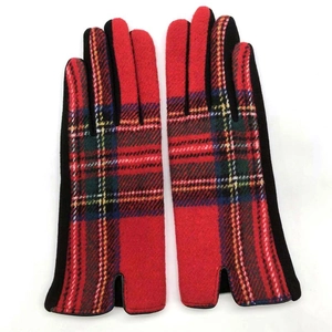Detail of red Scottish tartan wool gloves featuring side slits and black palm fabric