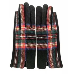 Detail of winter wool gloves with black knit fabric and Scottish tartan pattern on back