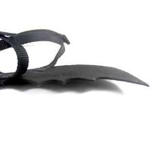 Macro detail of black felt bat wings for pets with adjustable nylon straps