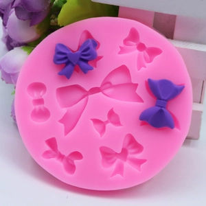 Pink silicone mold detail for creating various sizes of decorative fondant bows