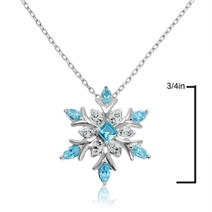Detailed view of silver snowflake necklace with blue gems and 3/4 inch size mark