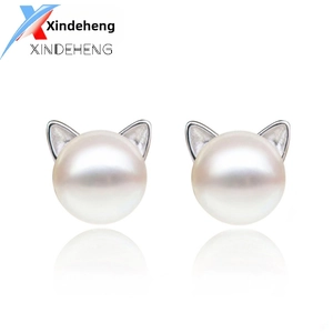 Detail of elegant 925 silver cat ear pearl earrings with polished white freshwater pearls