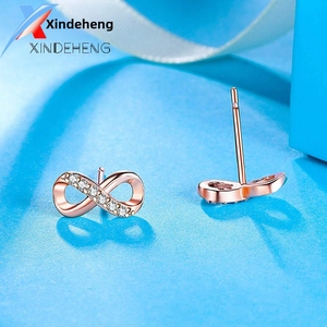 Detail showing infinity symbol stud earrings in rose gold with micro-pave diamond setting
