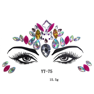 Detailed view of colorful crown-shaped acrylic face jewels and rhinestones on white background