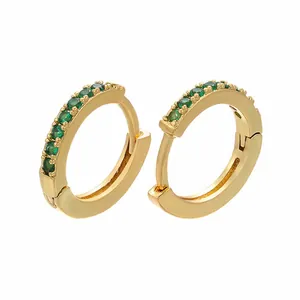 Detail of 18k gold plated huggie earrings featuring micro-paved green zircon stones