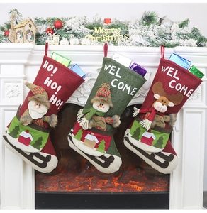 Three-piece Christmas stocking set featuring Santa and Reindeer hanging on a fireplace mantel
