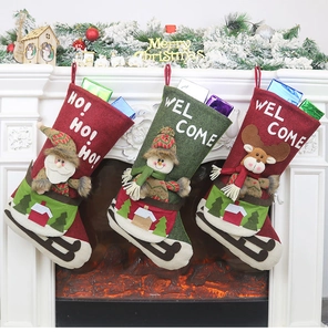 Close-up of felt Christmas stockings with 3D Santa, Snowman and Reindeer on a fireplace