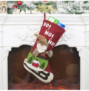 Detail of red and green Christmas stocking with Santa sleigh and HO! HO! HO! text