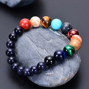 Solar system bracelet with blue goldstone and colorful beads on a grey stone base