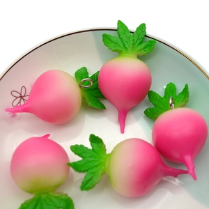 Realistic PVC radish keychain pendants with pink gradient in a decorative ceramic bowl