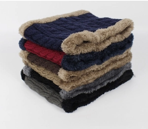 Detail of cable knit neck warmers in multiple colors with thick faux fur lining