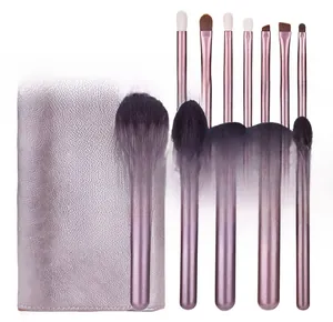 Close-up of 12 purple makeup brushes with soft bristles and leather storage bag