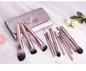 Detailed set of 12 rose gold makeup brushes with matching pink bow storage bag