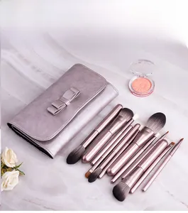 Detail view of 12-piece dusty pink makeup brush set with a matching ribbon storage bag