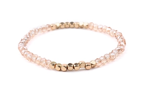 Macro detail of elastic champagne crystal beads and golden square metal beads bracelet
