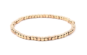 Detailed view of square gold beads and acrylic accents on this stretch beaded bracelet