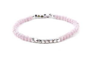 Detail view of faceted light pink crystal beads and silver square accents on elastic bracelet