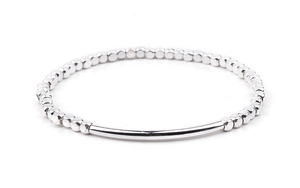Detail of silver beaded bracelet with polished curved tube and square metal beads