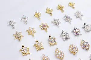 Detailed view of alloy nail charms with sunflower, turtle shapes, pearls and rhinestones