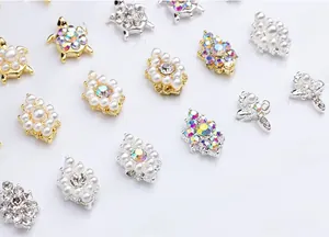 Detailed view of DIY nail charms with turtle designs and pearls in gold and silver plating