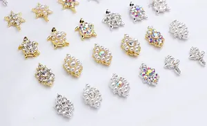 Detailed view of alloy nail art charms featuring turtles and stars with pearls and rhinestones