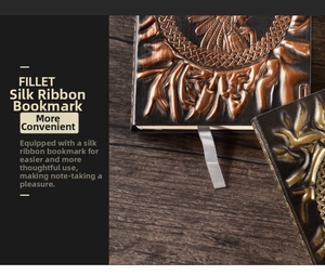 Detail of embossed vintage A5 notebook with ribbon bookmark on dark wood