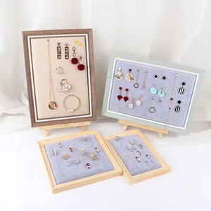 Wooden jewelry display set with light gray velvet inserts for earrings and rings