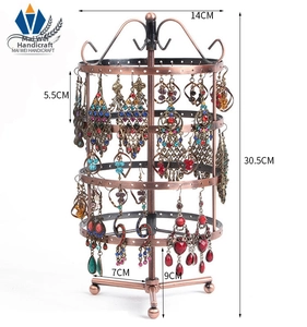 Detailed close-up of a 3-tier rotating metal earring display stand in copper finish
