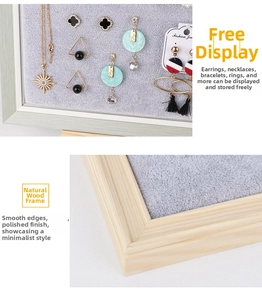 Macro shot of wooden frame jewelry display board with grey flocking for earrings